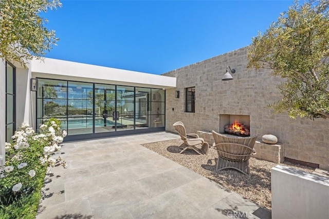 view of patio / terrace with an outdoor fireplace