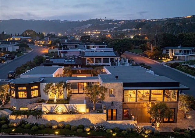 back house at dusk with a mountain view