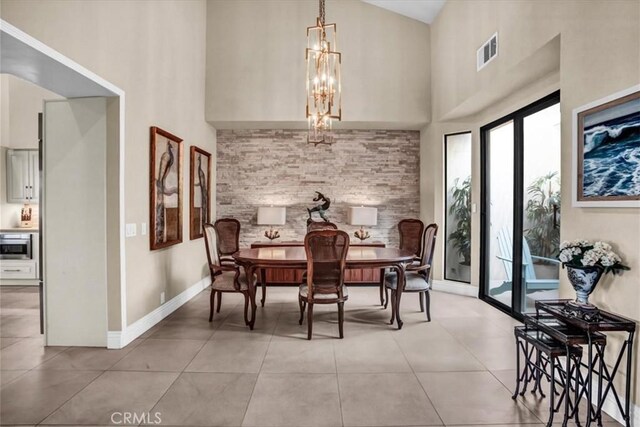 dining room featuring high vaulted ceiling, a notable chandelier, and light tile patterned floors