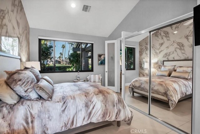 bedroom featuring lofted ceiling and a closet