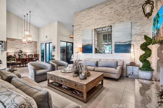 living room featuring a high ceiling and light tile patterned flooring