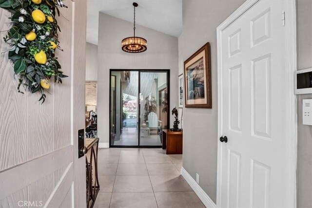 interior space featuring light tile patterned floors and vaulted ceiling