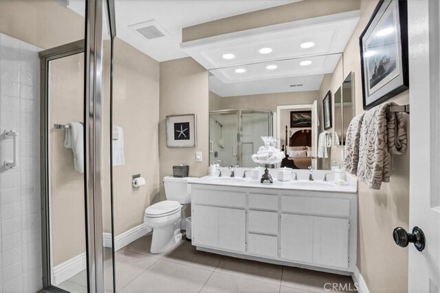 bathroom with toilet, a shower with door, vanity, and tile patterned flooring