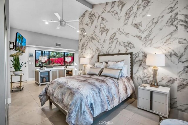 bedroom featuring light tile patterned flooring, ceiling fan, and beamed ceiling