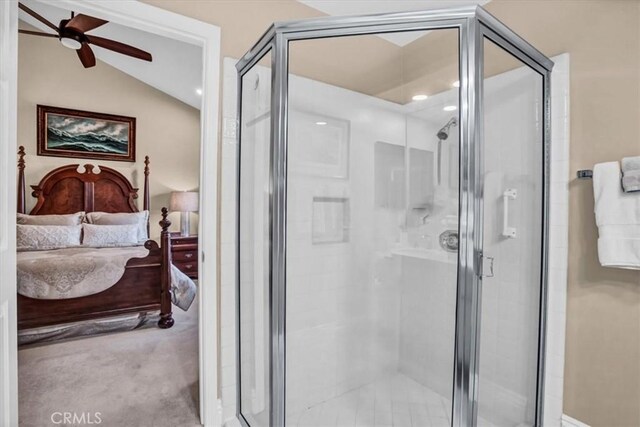 bathroom featuring vaulted ceiling, an enclosed shower, and ceiling fan