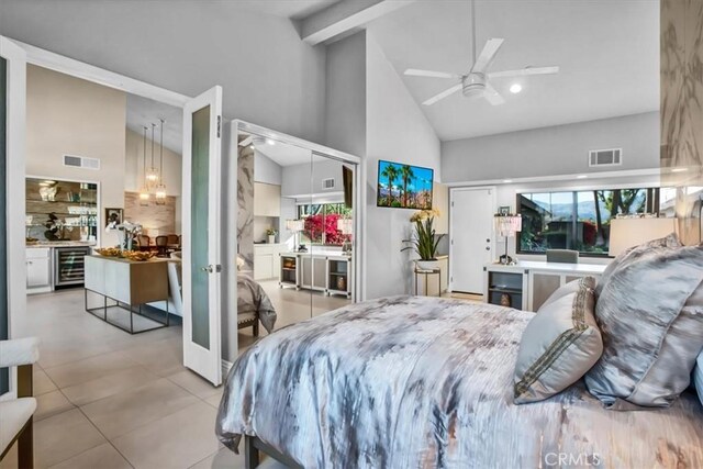 bedroom with wine cooler, beamed ceiling, light tile patterned floors, ceiling fan, and high vaulted ceiling