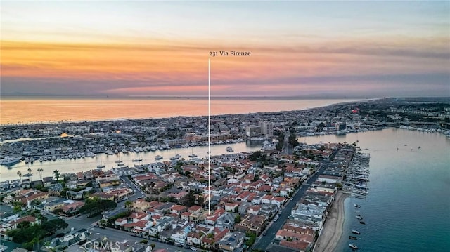 aerial view at dusk with a water view