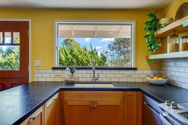 kitchen with dishwasher, backsplash, and sink