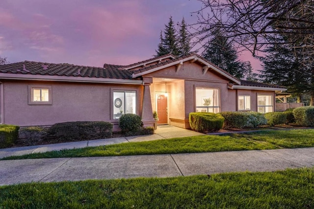 ranch-style house with a lawn