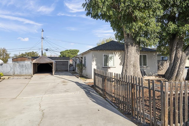 view of front of property featuring a garage and an outbuilding