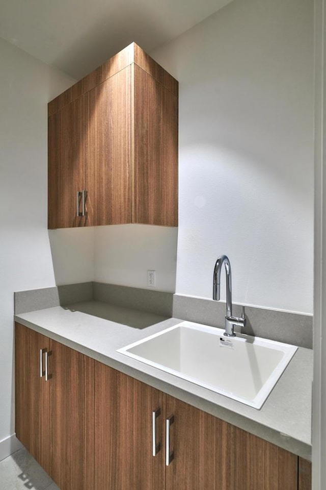 kitchen featuring sink and light tile patterned floors