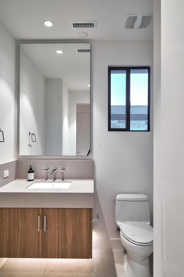 bathroom featuring tile patterned floors, vanity, and toilet