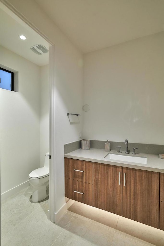 bathroom featuring toilet, tile patterned floors, and vanity