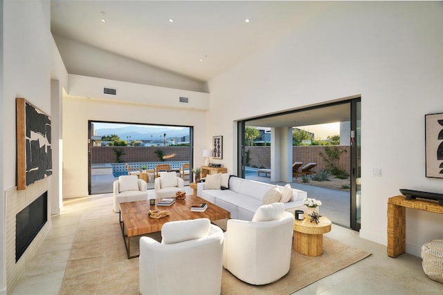 living room featuring high vaulted ceiling