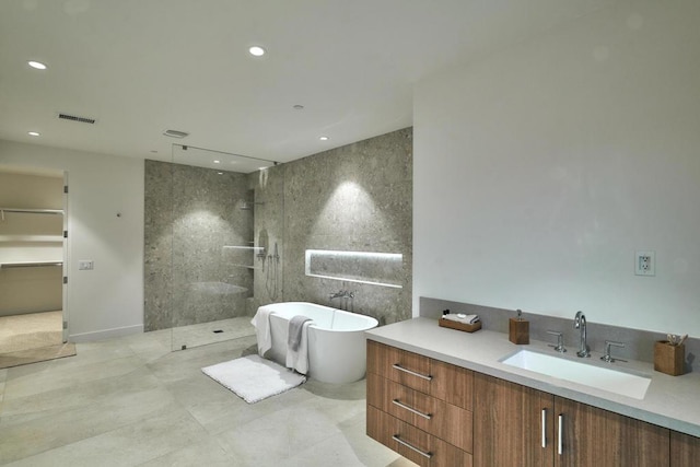 bathroom with shower with separate bathtub and vanity