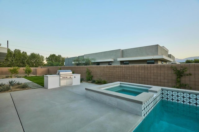 view of pool with a patio, area for grilling, and an in ground hot tub