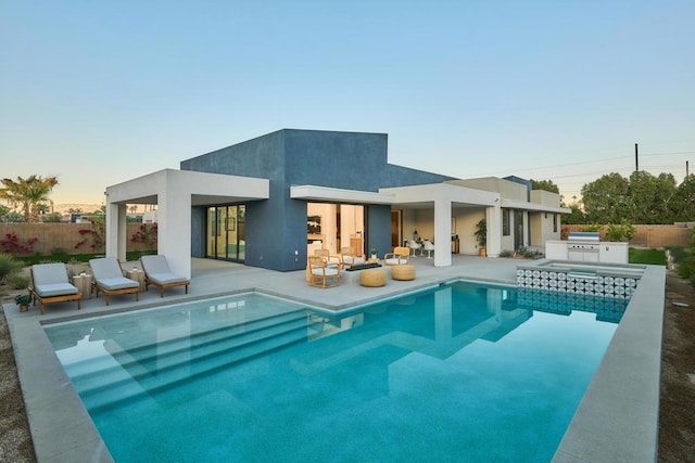 back of house featuring an outdoor kitchen and a patio area