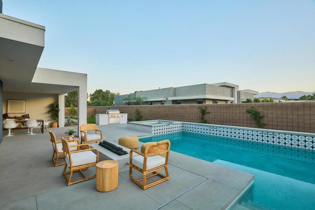 view of pool featuring exterior kitchen, an in ground hot tub, and a patio