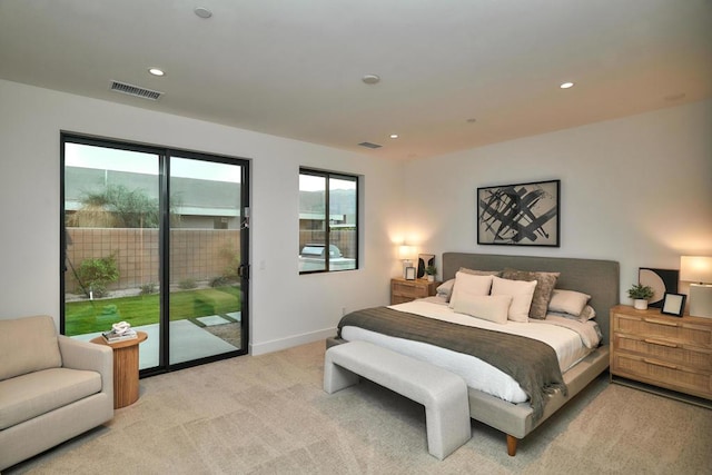 bedroom with access to exterior and light colored carpet