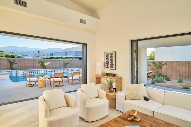 living room featuring vaulted ceiling and a mountain view