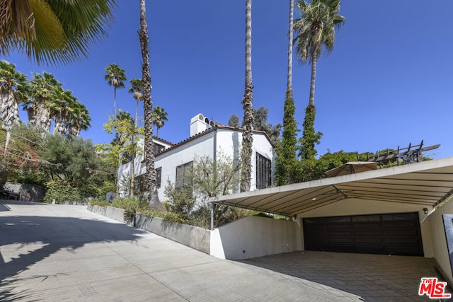 view of side of home with a carport