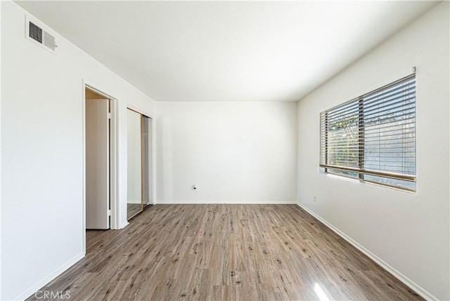 empty room with hardwood / wood-style floors