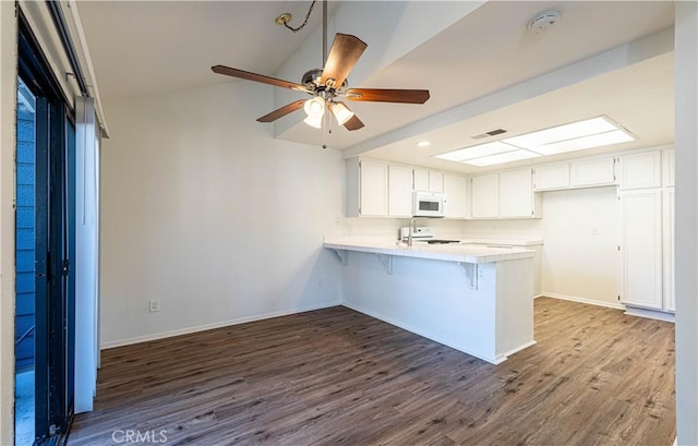 kitchen featuring white cabinetry, ceiling fan, stove, kitchen peninsula, and dark wood-type flooring