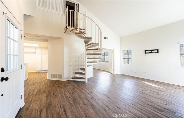 interior space with high vaulted ceiling and dark hardwood / wood-style floors