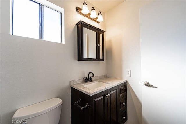 bathroom with toilet and vanity