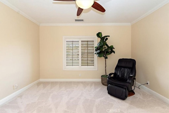 sitting room featuring visible vents, carpet floors, and ornamental molding