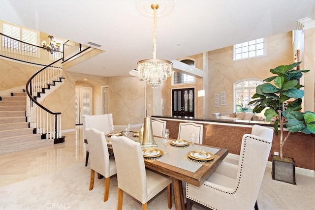 dining room with stairway, a notable chandelier, and visible vents