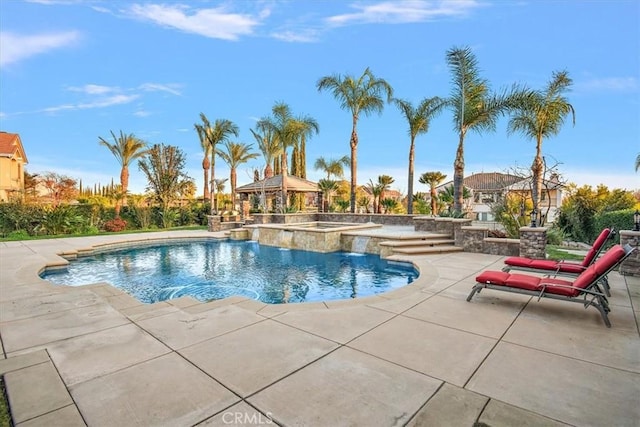 outdoor pool with a gazebo, a patio, and an in ground hot tub