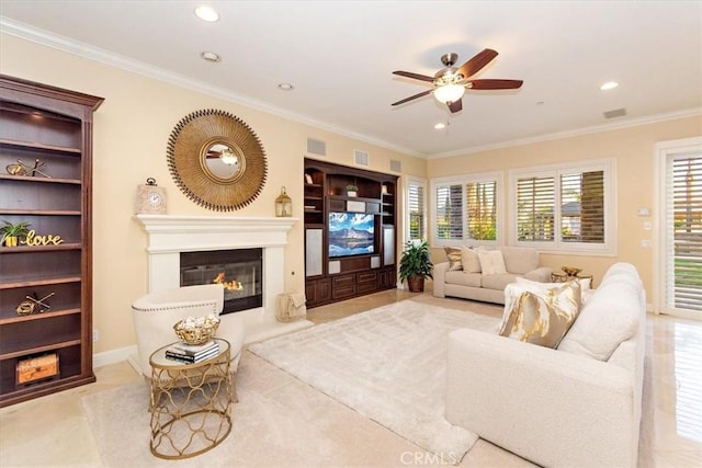 living room featuring a glass covered fireplace, built in shelves, visible vents, and ornamental molding