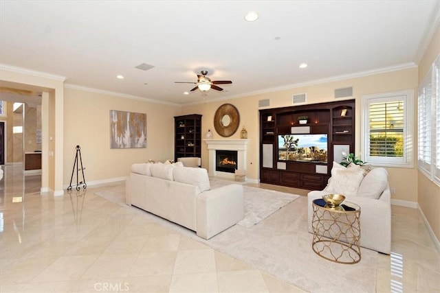 living room with visible vents, crown molding, baseboards, a lit fireplace, and recessed lighting