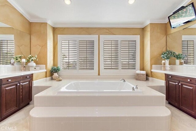 full bathroom featuring vanity, a garden tub, a wealth of natural light, and ornamental molding