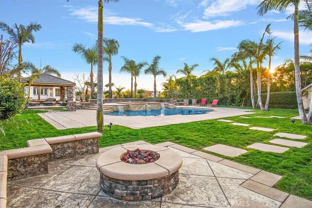 pool featuring a gazebo, a lawn, an outdoor fire pit, and a patio