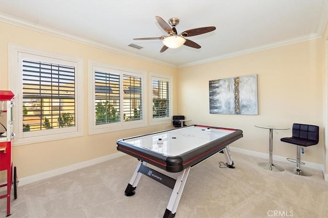 rec room with visible vents, baseboards, carpet floors, ceiling fan, and ornamental molding