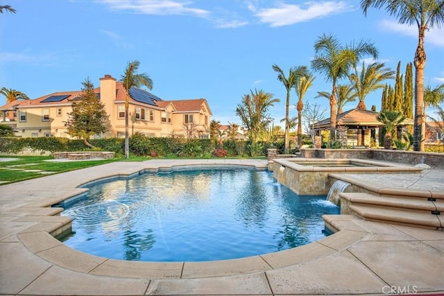 pool with a gazebo and an in ground hot tub