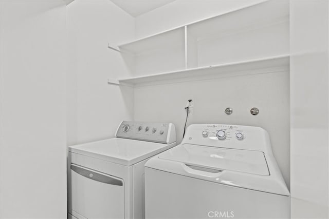 clothes washing area with washing machine and clothes dryer