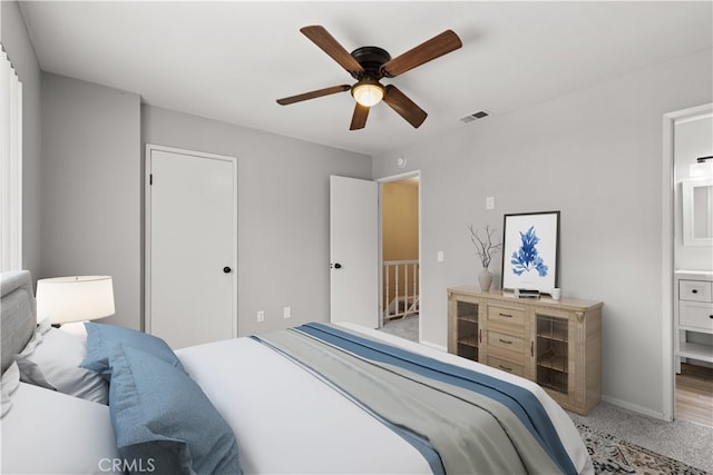 bedroom featuring ceiling fan, carpet flooring, and ensuite bath