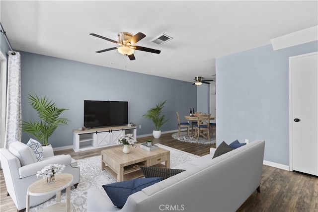 living room with dark hardwood / wood-style floors and ceiling fan