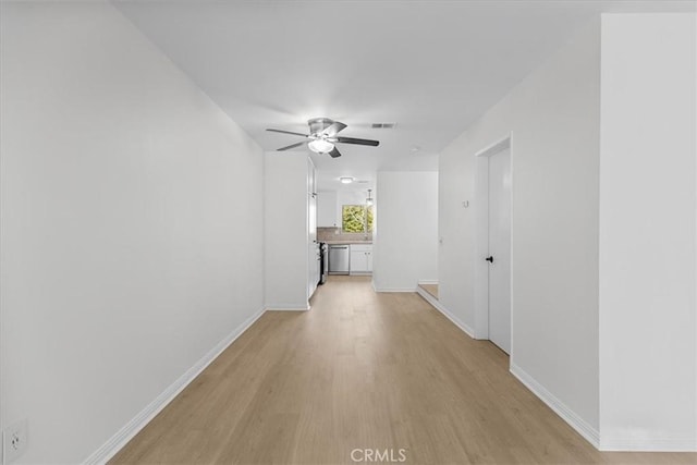 hallway with light wood-type flooring