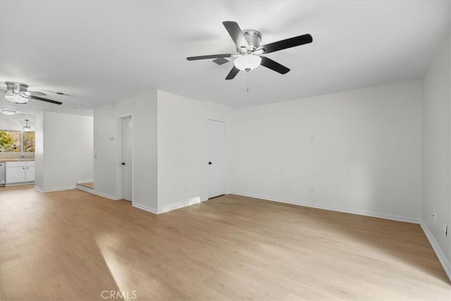 spare room featuring ceiling fan and light wood-type flooring