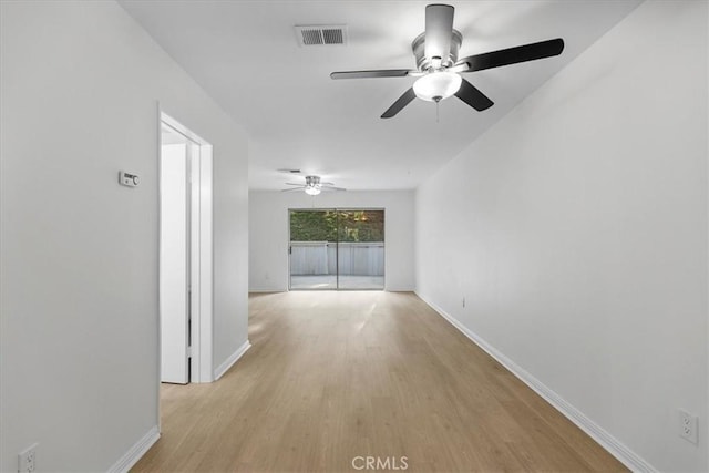 spare room with ceiling fan and light wood-type flooring