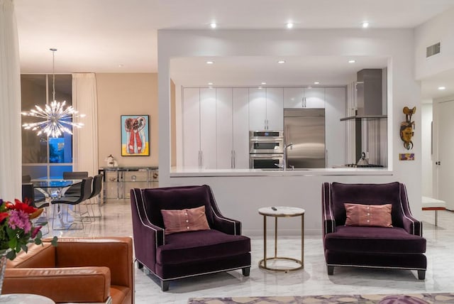 kitchen with stainless steel appliances, a notable chandelier, pendant lighting, wall chimney exhaust hood, and white cabinetry