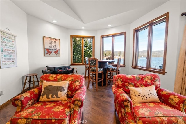 living room featuring a water view, lofted ceiling, and dark hardwood / wood-style floors