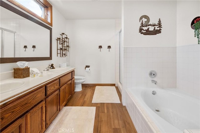 full bathroom featuring toilet, vanity, hardwood / wood-style flooring, and plus walk in shower