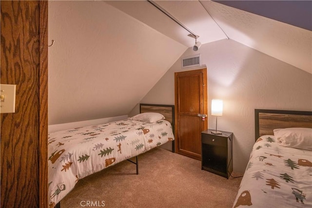 carpeted bedroom with vaulted ceiling