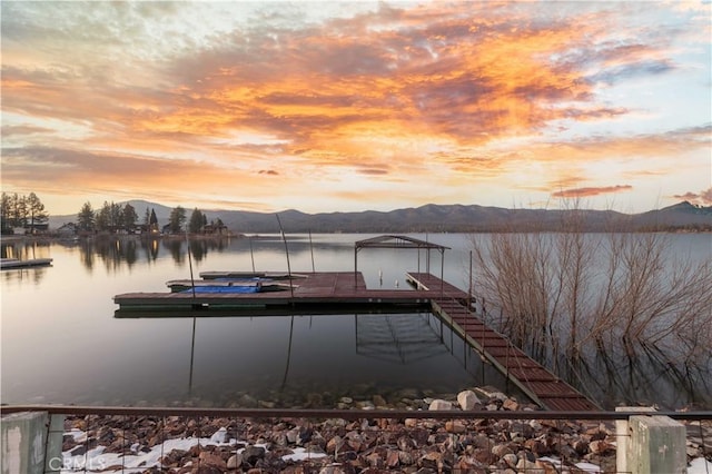 view of dock with a water and mountain view