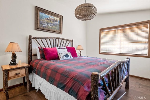 bedroom featuring dark hardwood / wood-style flooring and vaulted ceiling